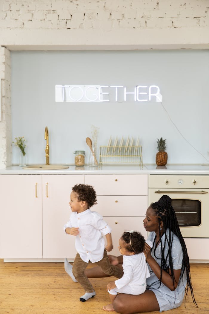 Mother and children enjoying quality time together in a stylish kitchen.